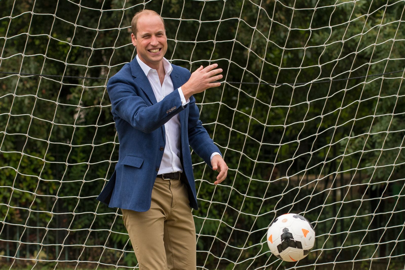 Image may contain Prince William Duke of Cambridge Ball Football Soccer Soccer Ball Sport Accessories and Belt