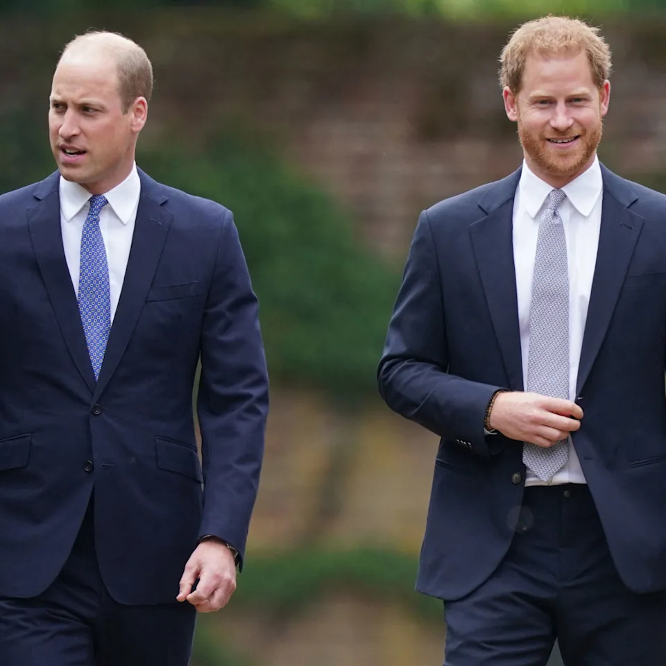 Prince William and Prince Harry both wearing suits, white shirts, and ties.