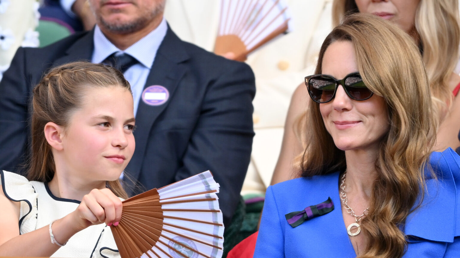 Princess Charlotte fans her mom Kate Middleton at Wimbledon as they watch the tennis tournament during a heat wave