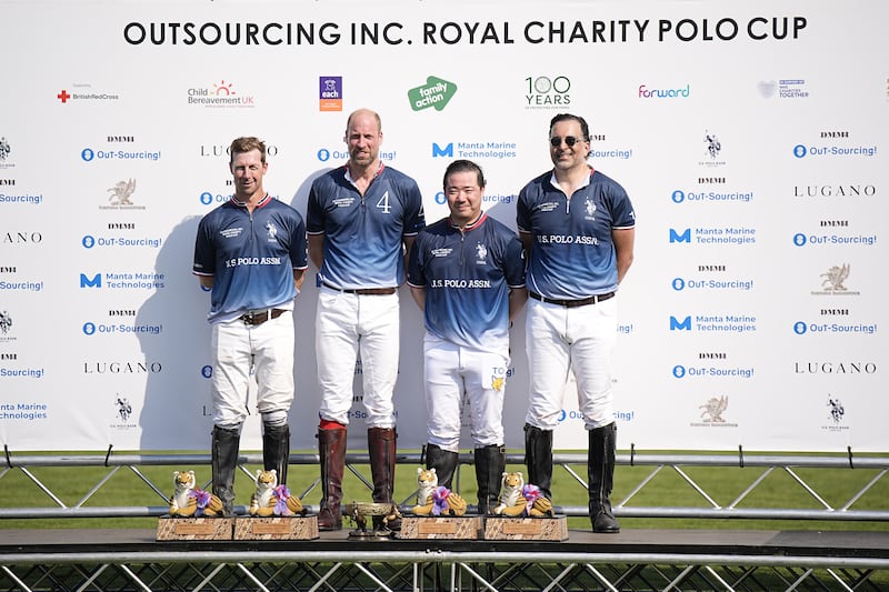The Prince of Wales (second left) stands with his winning team
