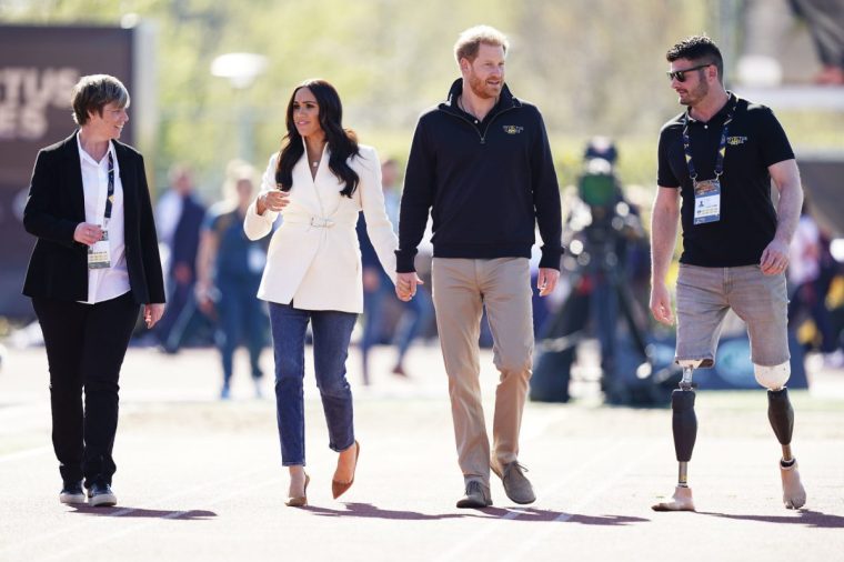 File photo dated 17/04/22 of the Duke and Duchess of Sussex, with Invictus Games trustee and paralympian Dave Henson (right), attending the Invictus Games athletics events in the Athletics Park, at Zuiderpark the Hague, Netherlands.The Duke of Sussex has appeared at a special US screening of his new Netflix documentary, Heart Of Invictus. The docu-series follows a group of service members on their road to the paralympic-style sporting competition which Harry set up in 2014 for injured and sick military personnel and veterans. Issue date: Wednesday August 30, 2023. PA Photo. See PA story SHOWBIZ Invictus. Photo credit should read: Aaron Chown/PA Wire