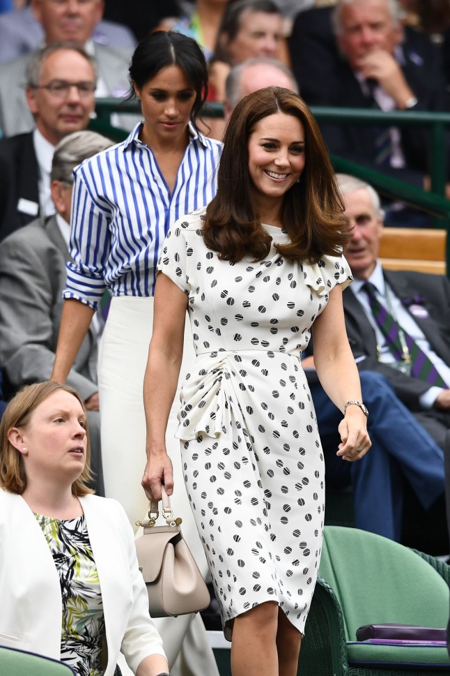 LONDON, ENGLAND - JULY 14: Meghan, Duchess of Sussex and Catherine, Duchess of Cambridge attend day twelve of the Wimbledon Lawn Tennis Championships at All England Lawn Tennis and Croquet Club on July 14, 2018 in London, England. (Photo by Clive Mason/Getty Images)