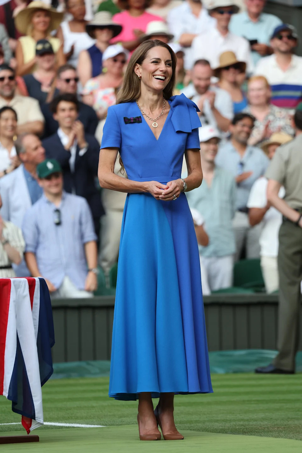 The family color-coordinated in blue and white looks, with Middleton sporting a bright blue belted dress. ZUMAPRESS.com