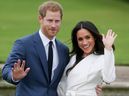 This file photo taken on Nov. 27, 2017 shows Prince Harry and his fiancee Meghan Markle posing for a photograph in the Sunken Garden at Kensington Palace in west London following the announcement of their engagement.  