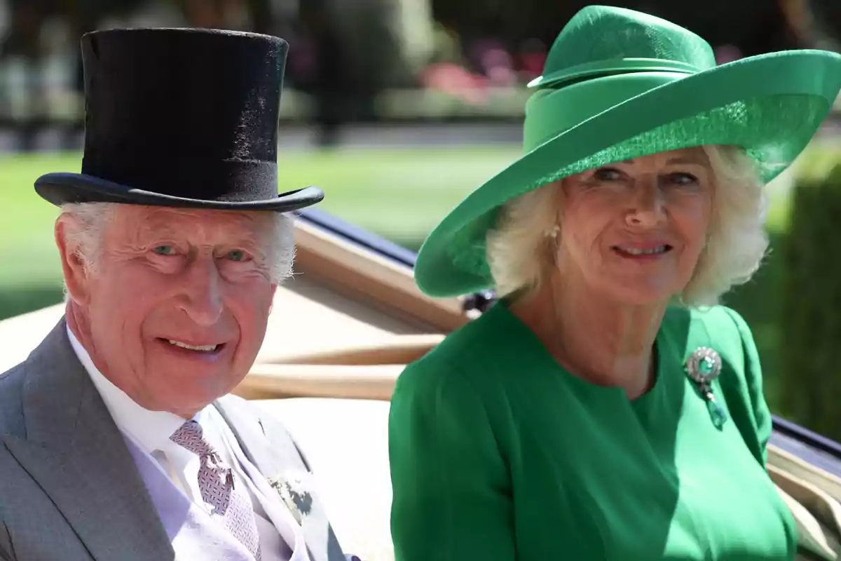 King Charles III in a black top hat and Queen Camilla in a green hat pose smiling, dressed elegantly at an outdoor event. King Charles III in a black top hat and Queen Camilla in a green hat pose smiling, dressed elegantly at an outdoor event.