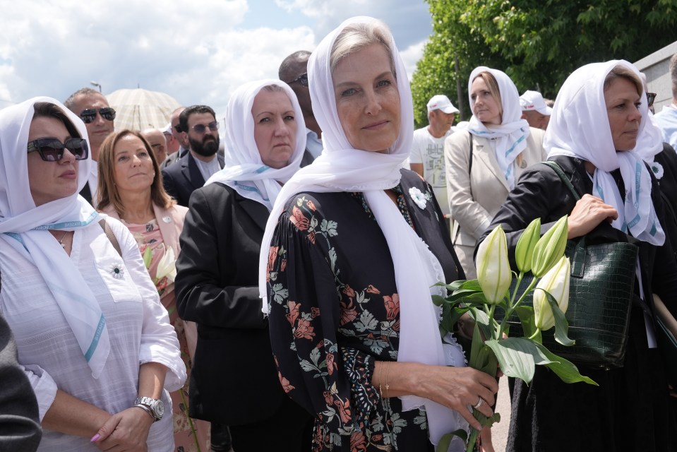 The Duchess of Edinburgh laying flowers at a cemetery.