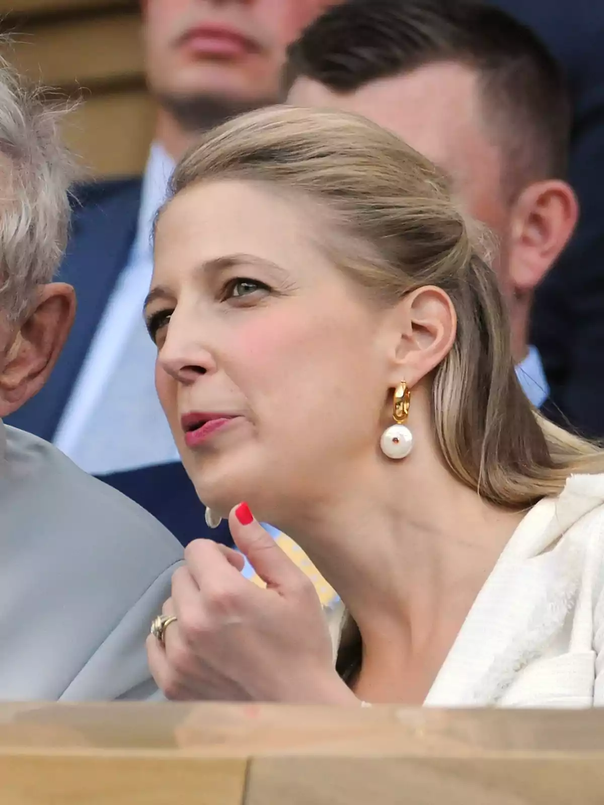 Gabriella Windsor with large earrings and her hair up is gesturing while conversing at a formal event. Gabriella Windsor with large earrings and her hair up is gesturing while conversing at a formal event.