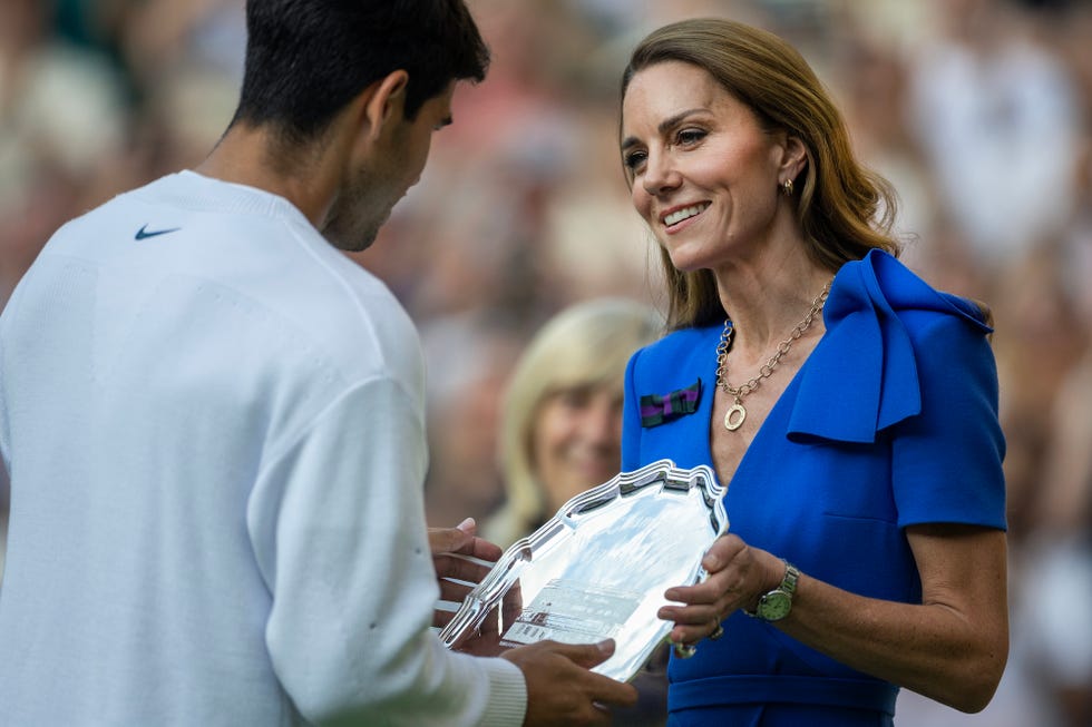 london, england july 13: catherine, princess of wales, presents carlos alcaraz of spain with the runners up trophy at the presentation ceremony of the gentlemen's singles final on centre court during the wimbledon lawn tennis championships at the all england lawn tennis and croquet club at wimbledon on july 13th, 2025, in london, england. (photo by tim clayton/getty images)