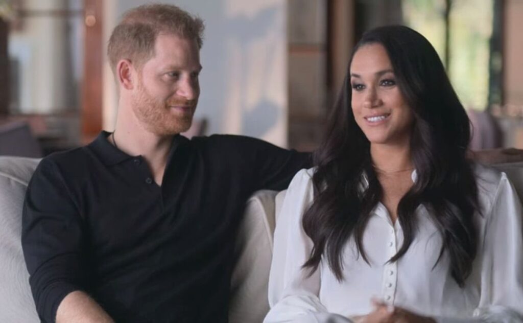Prince Harry and Meghan Markle speaking to the camera in their documentary, Harry & Meghan