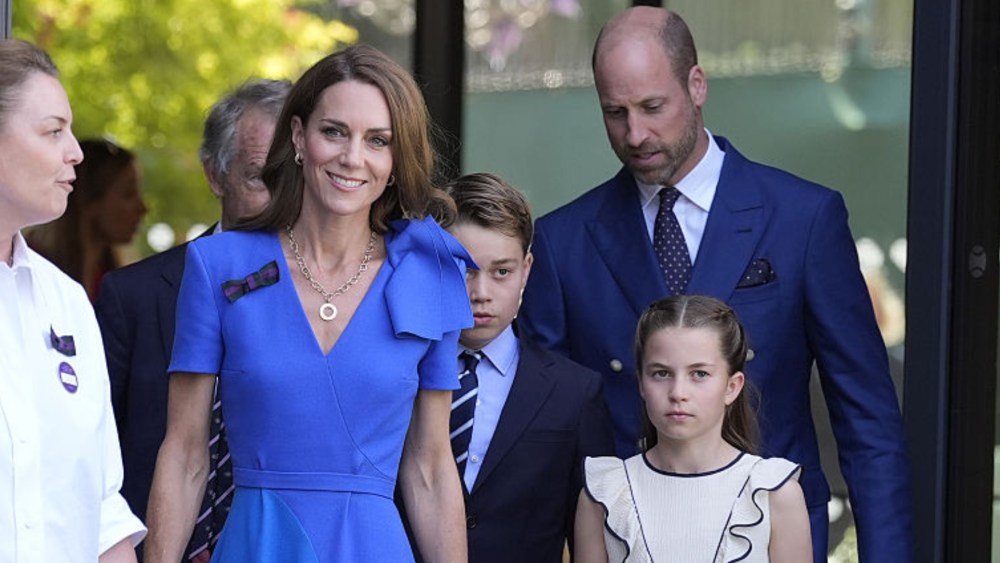 Kate Middleton (centre), Princess Charlotte (second right) and William, Prince of Wales (right), are greeted by Sally Ambrose (left), a member of the Committee of Management of The Championships, as they arrive during day fourteen of The Championships Wimbledon 2025.