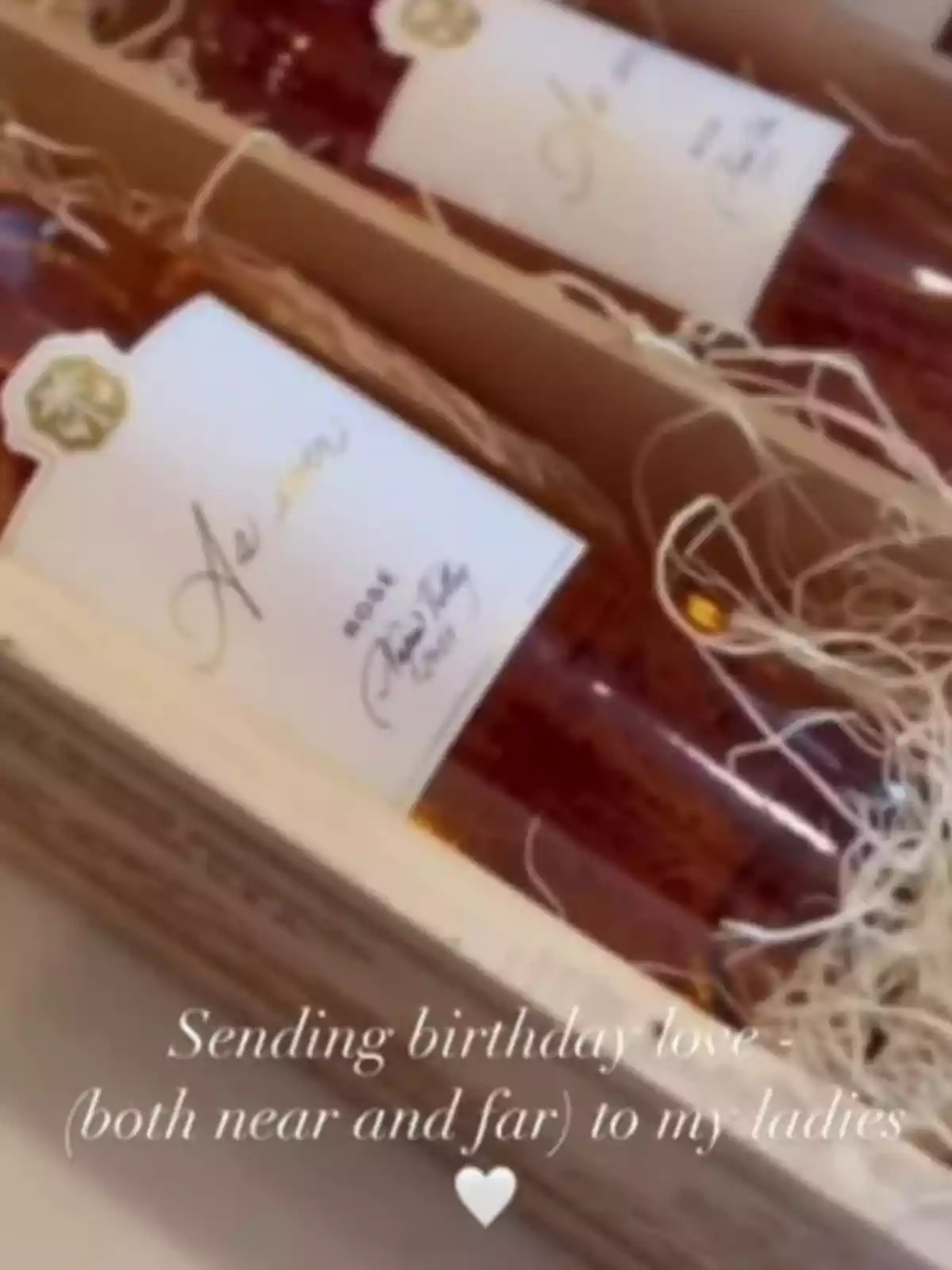 Meghan Markle posts some bottles of rosé wine in a wooden box with decorative shavings and a message that says sending birthday love to my friends.