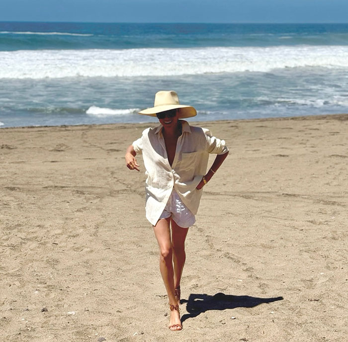 Meghan Markle walking on the beach in a wide-brimmed hat and light outfit amid fruit-picking photo fraud accusations. Meghan Markle walking on the beach in a wide-brimmed hat and light outfit amid fruit-picking photo fraud accusations.