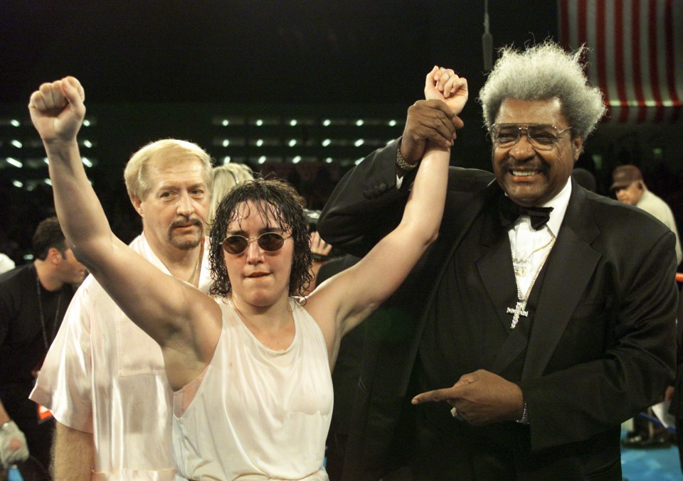 Don King raises the arm of Christy Martin after her boxing victory.