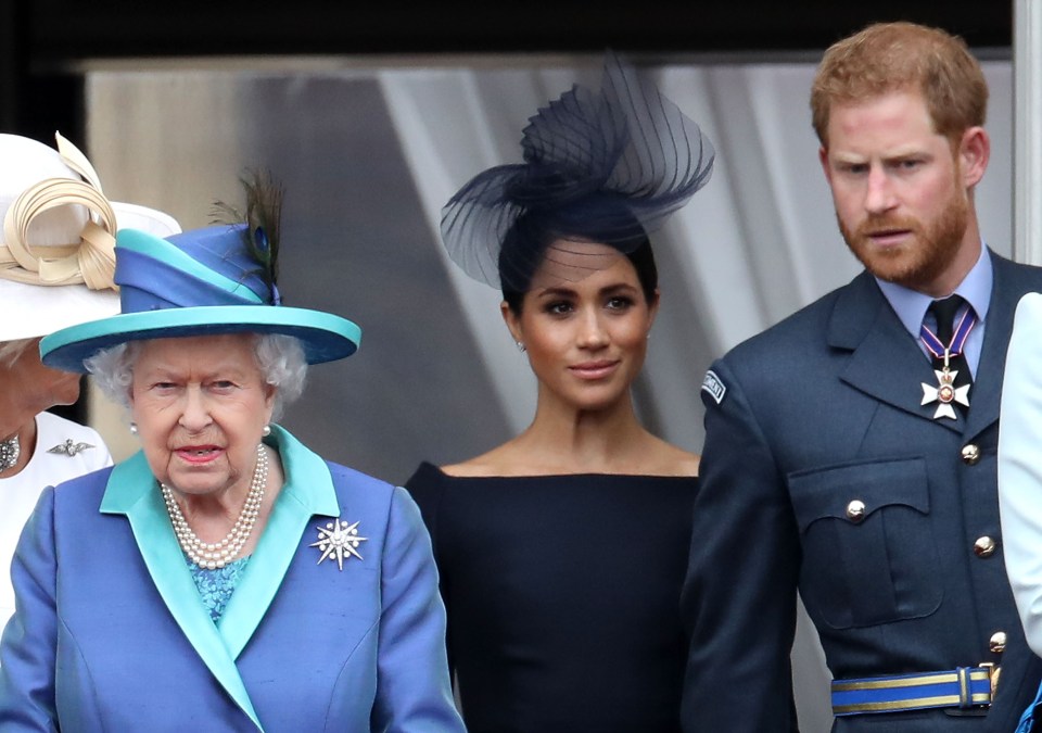 Queen Elizabeth II, Prince Harry, and Meghan Markle on the Buckingham Palace balcony.