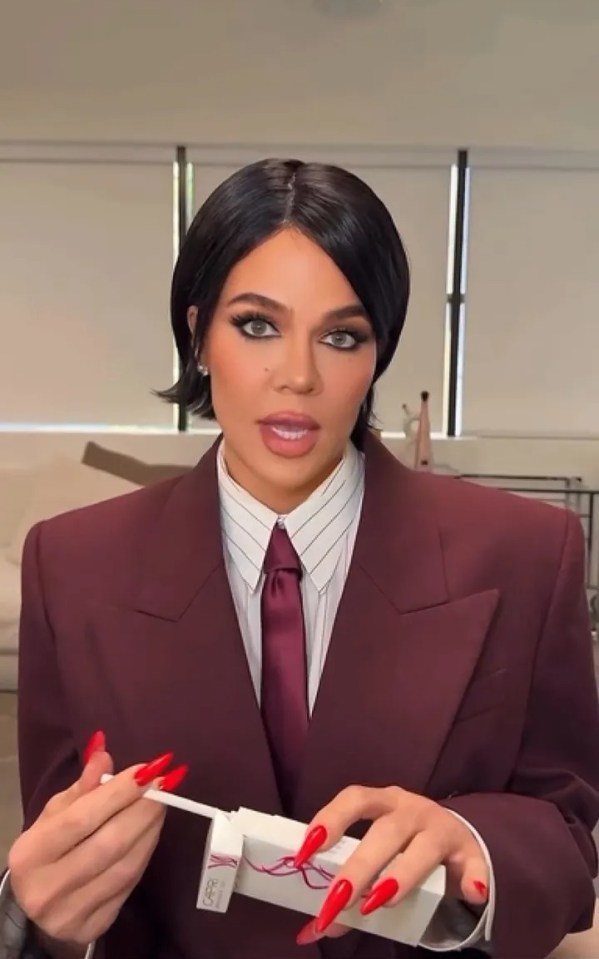 Khloe Kardashian in a suit promoting a video.