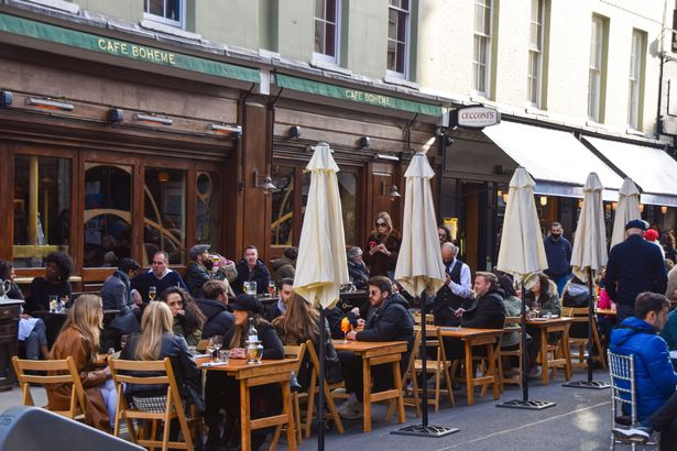 People seen sitting at the Cafe Boheme in Old Compton Street, Soho in London on 04/12/2021