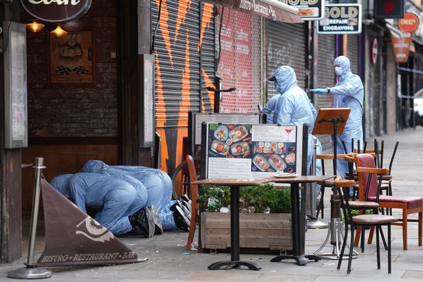 Forensic officers at the scene of the shooting