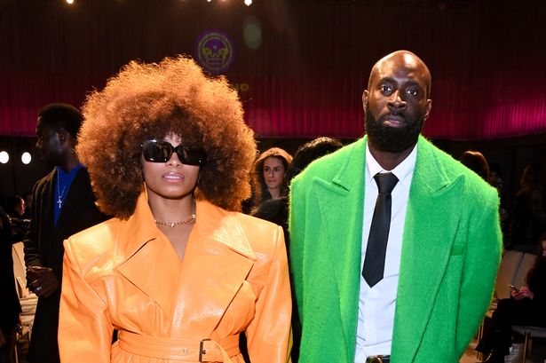 Fleur East and husband in orange and green outfits