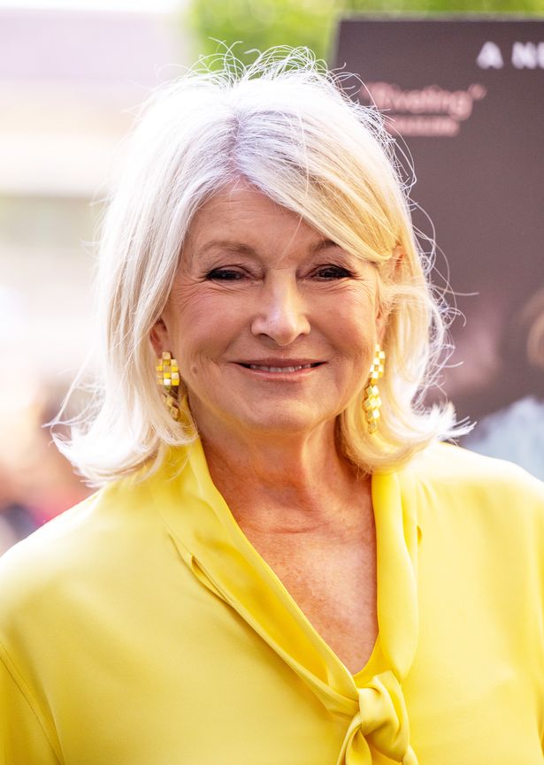 Martha Stewart dressed in yellow and smiling at cameras