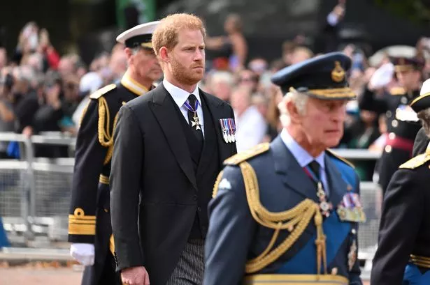 Sir Timothy Laurence, Prince Harry, Duke of Sussex and King Charles III walk behind the coffin during the procession for the Lying-in State of Queen Elizabeth II on September 14, 2022