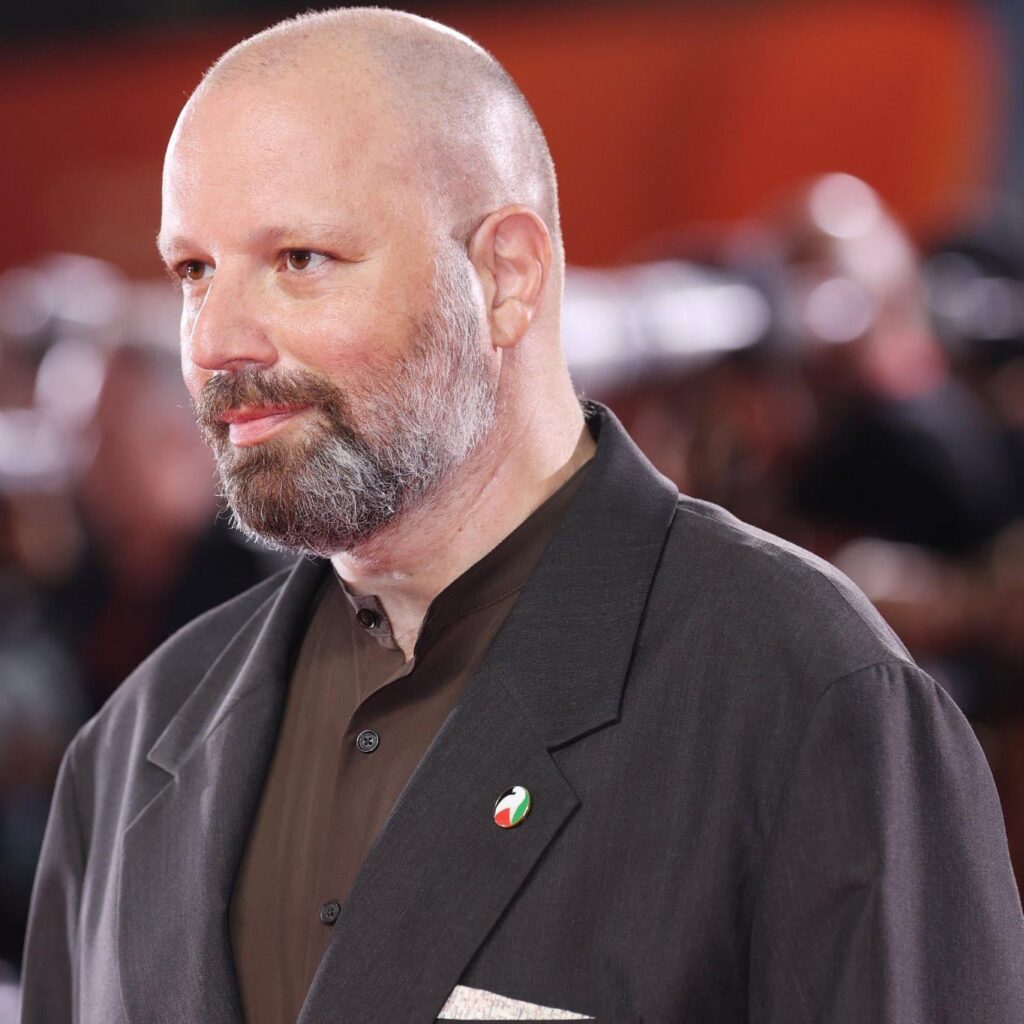 Yorgos Lanthimos wears a Palestine pin at the Venice Film Festival premiere of "Bugonia"