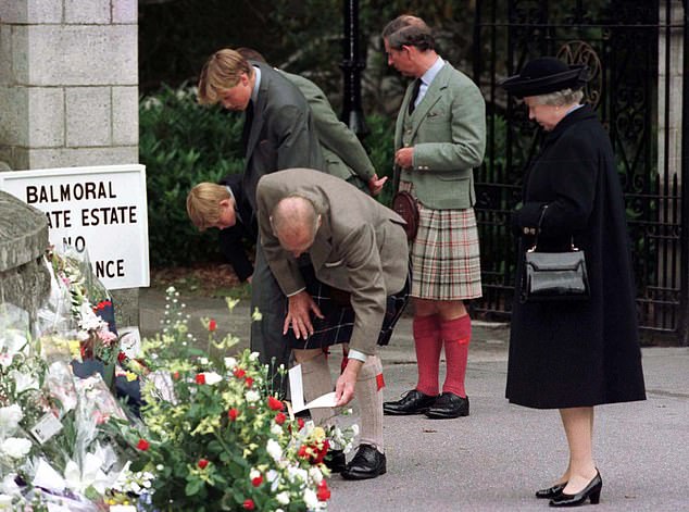 The family view floral tributes on display outside the gates of Balmoral September 4, 1997