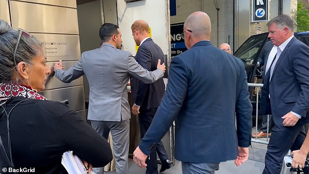 'Harry is left faltering slightly, having to raise an arm to show he will follow Meghan, just as the greeter raises her to usher him along,' wrote James