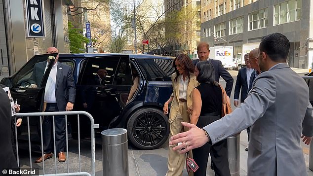 The body language expert said that as their car pulls up, Harry 'defines Meghan as the star' by sprinting around to reach his wife as she emerges