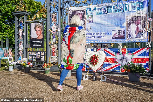 Well-wishers placed flowers, flags and banners dedicated to the late Diana Spencer on the golden gates to the south of the West London royal home today