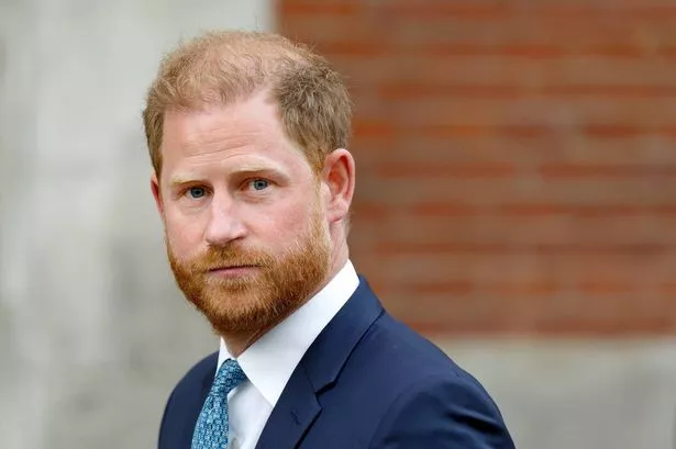 Prince Harry in a close up photo wearing a suit