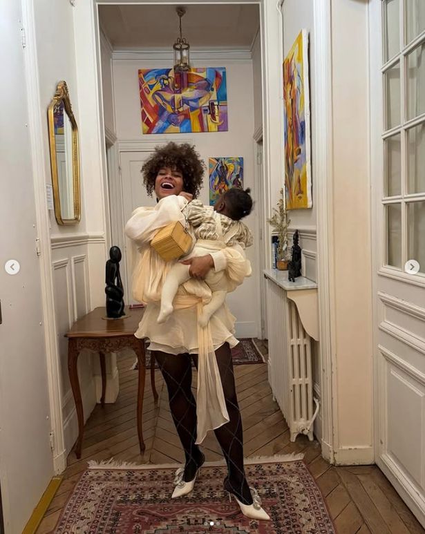Fleur east holding baby daughter in arms