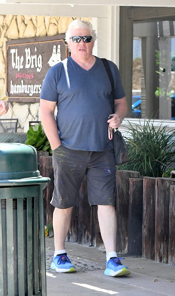 Thomas F. Wilson, known for his role as Biff Tannen in Back to the Future, walking down the street.