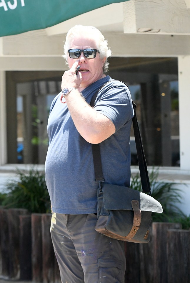 Thomas F. Wilson, actor known for his role as Biff Tannen in Back to the Future, wearing a blue shirt and sunglasses.