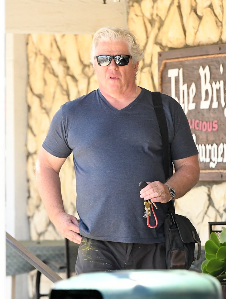 Thomas F. Wilson, known for his role as Biff Tannen in Back to the Future, wearing a black t-shirt and sunglasses.