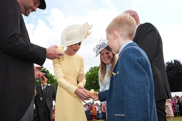 AARON CHOWN/POOL/AFP via Getty Princess Kate catching up with Liz Hatton's family at Buckingham Palace in May 2025
