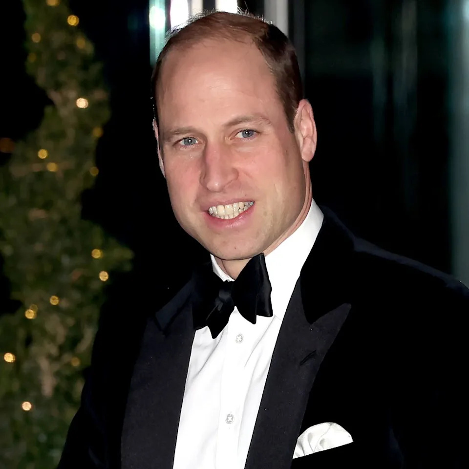 Prince William wearing a tuxedo and smiling. 