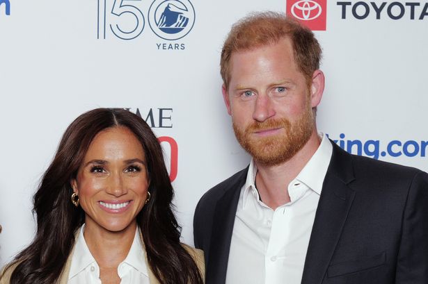 Meghan Markle, in a beige suit, and Prince Harry, in a dark suit, at an event in 2025.