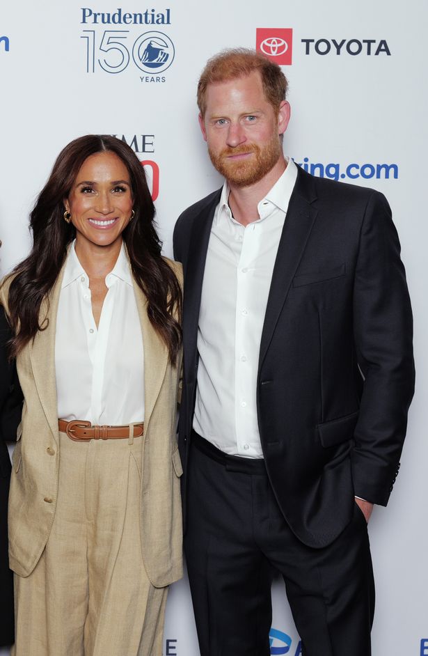 Meghan Markle, in a beige suit, and Prince Harry, in a dark suit, at an event in 2025.