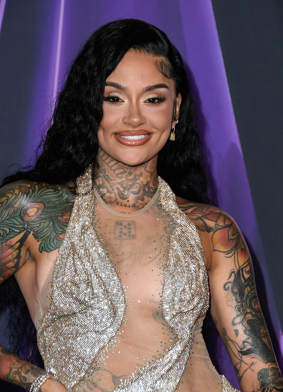 Kehlani smiling on a formal event carpet