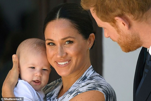 Prince Harry and Meghan Duchess of Sussex, holding their son Archie Harrison Mountbatten-Windsor in 2019