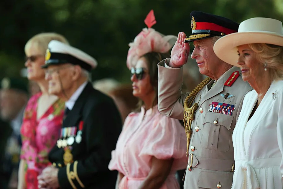 alrewas, staffordshire august 15: king charles iii salutes while stood next to queen camilla as they attend the service of remembrance to commemorate the 80th anniversary of vj day at the national memorial arboretum on august 15, 2025 in alrewas, staffordshire. the service commemorates the 80th anniversary of victory over japan day, or vj day, which marks the announcement of japans acceptance of the terms of the potsdam declaration on august 15, 1945, effectively bringing wwii to an end. (photo by alastair grant wpa pool/getty images)