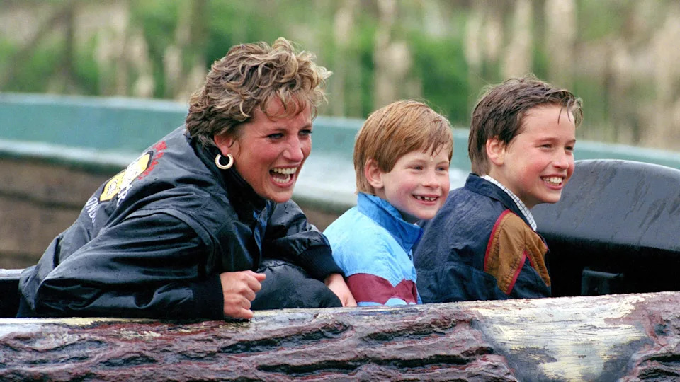 Princess Diana with her sons at an amusement park. Prince Harry's visit to London will come after the anniversary of Diana's death on August 31. / Julian Parker / UK Press via Getty Images
