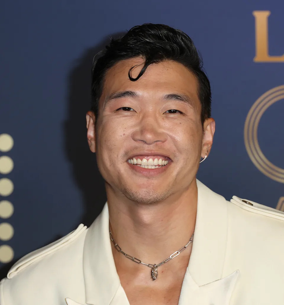 Joel Kim Booster smiling at an event