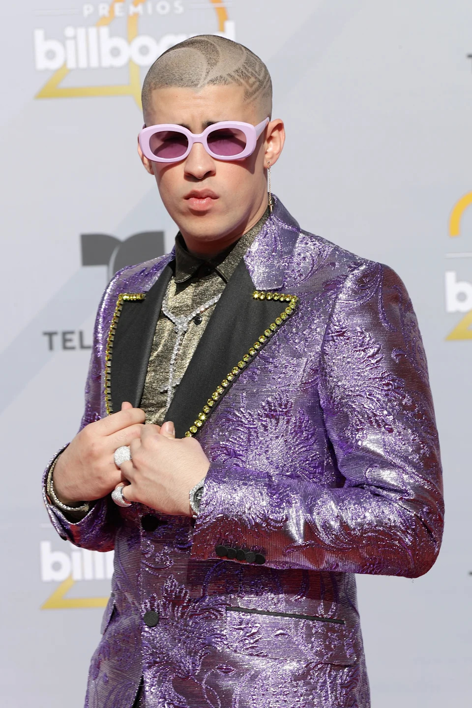 Bad Bunny seemingly clenching his jaw at an event