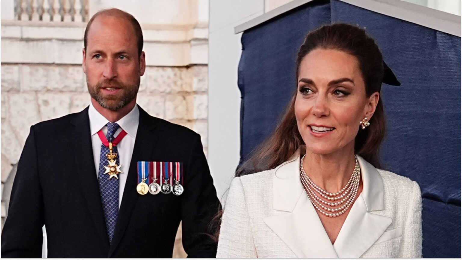 Prince William wears a suit and military medals and Kate Middleton wears a cream coat dress with a floppy black bow