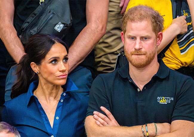 Prince Harry and Meghan Markle looking serious