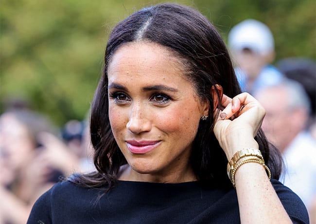 Meghan Markle looking at floral tributes Windsor Castle
