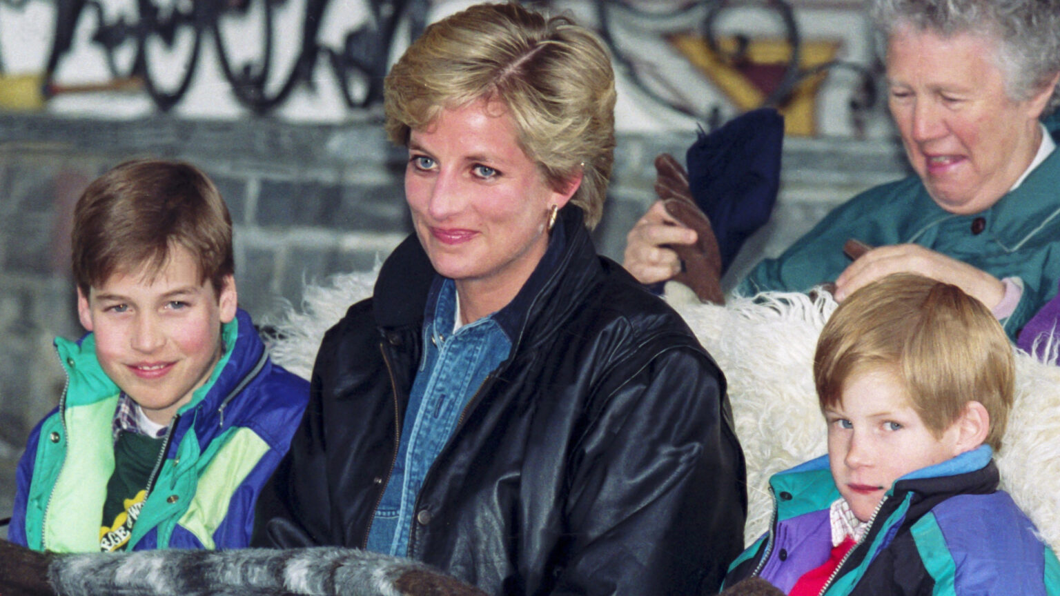 Prince William, Princess Diana, and Prince Harry ride in a sleigh