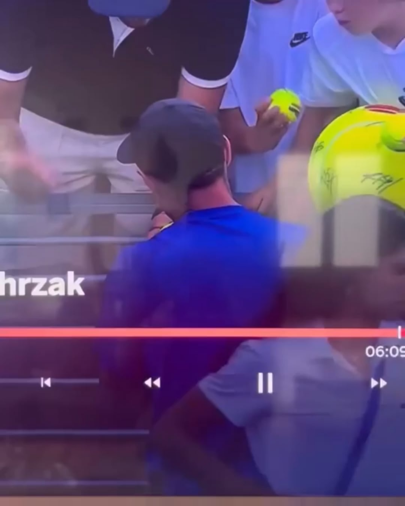 A man grabs Kamil Majchrzak's hat that the player wanted to give to a kid. Then quickly hides it in his wifes bag