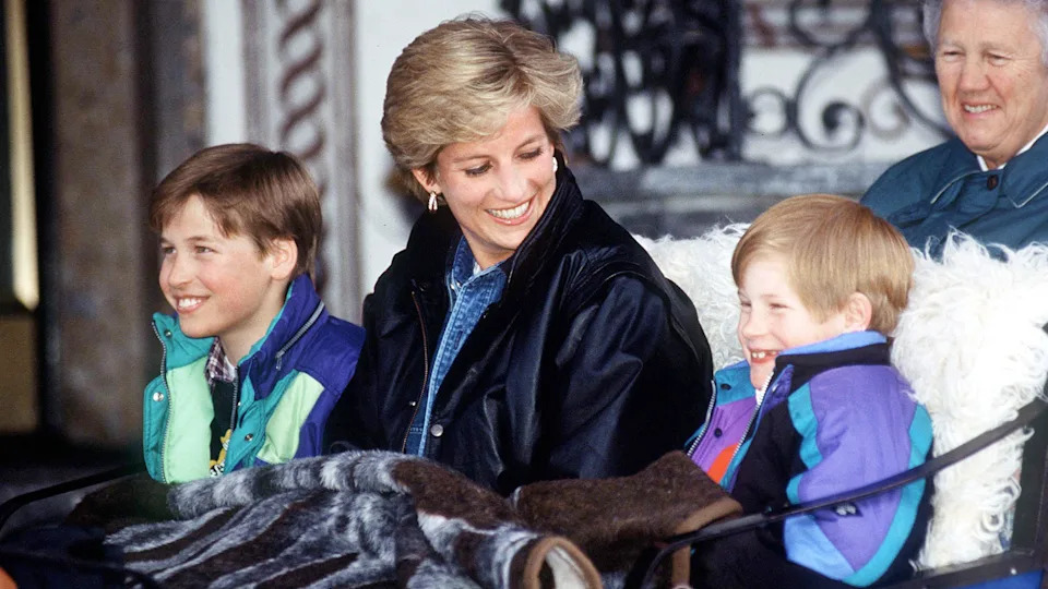 LECH, AUSTRIA - MARCH 30: Princess Diana With Prince William And Prince Henry (harry) In Lech, Austria. They Are Sitting In A Carriage With A Blanket Covering Them. Sitting Behind Is Their Nanny Olga Powell. (Photo by Tim Graham Photo Library via Getty Images)